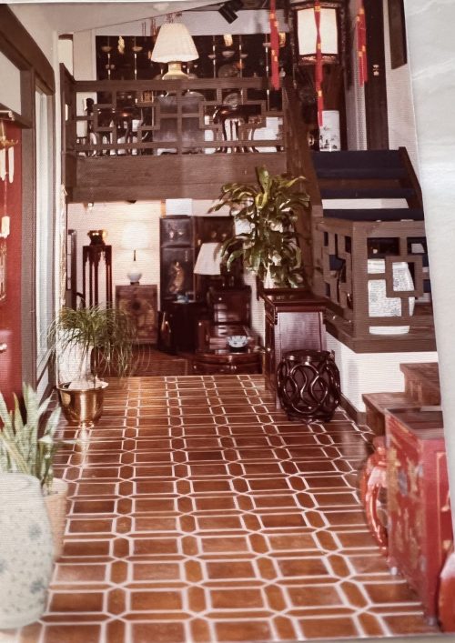 View looking at the stairs going up to the top level and stairs going down to the lower level. The front door is to the left.
